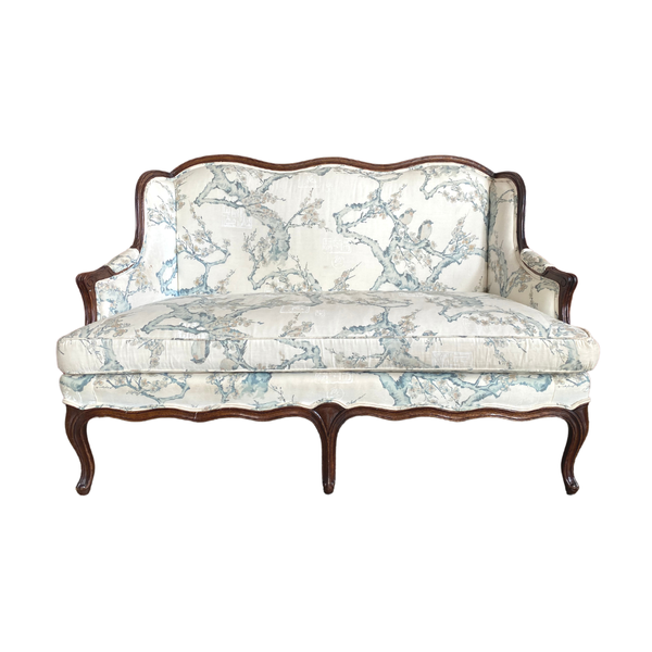 White settee with blue green cherry blossom pattern