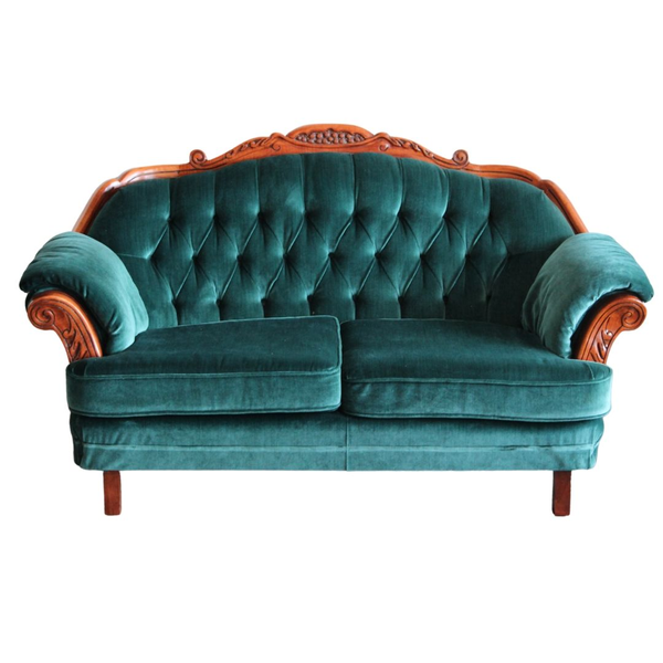 Dark turquoise settee with a tufted back and carved wood details 