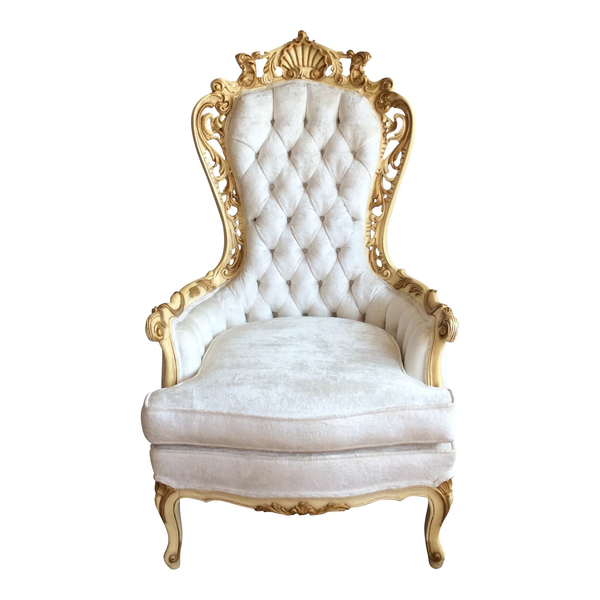 White tufted throne chair with ornate gold detailing