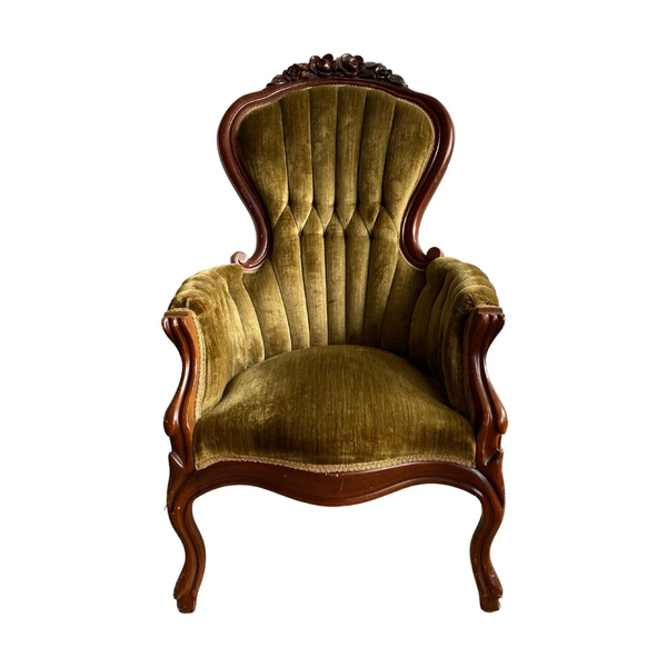 Olive color throne chair with tufted back and carved wood detailing