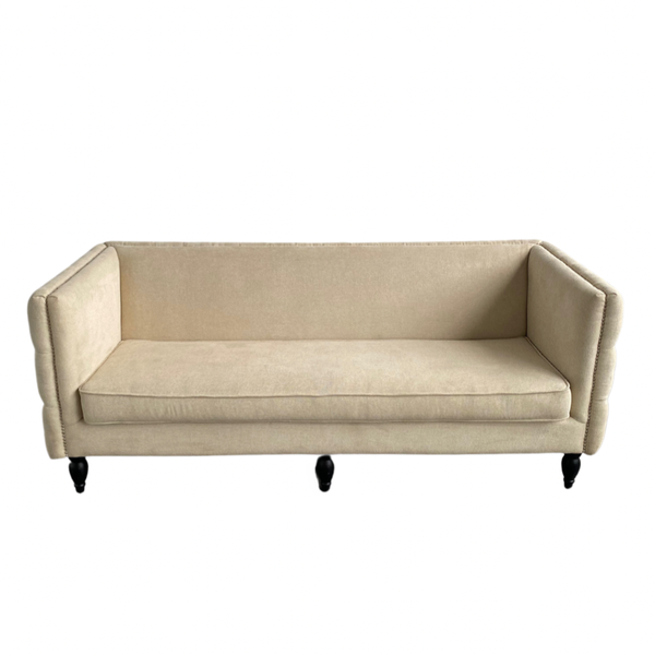 Cream sofa with tufted back perfect for a neutral wedding lounge