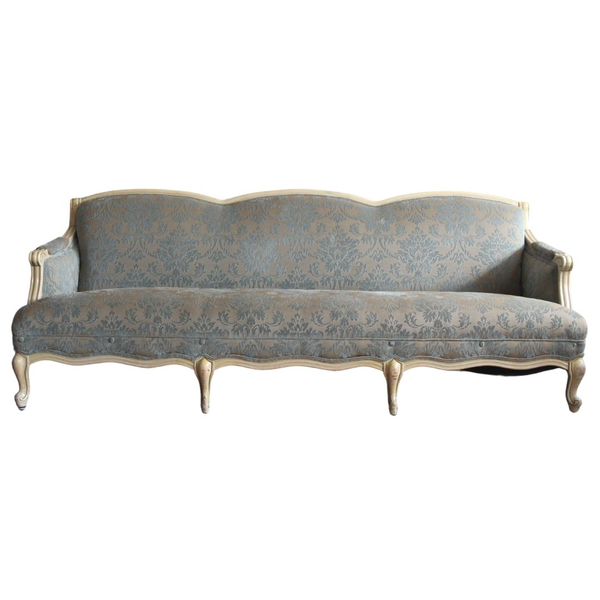 Patterned powder blue sofa with white wood details