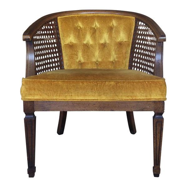 Mustard yellow tufted armchair with rattan and dark wood details