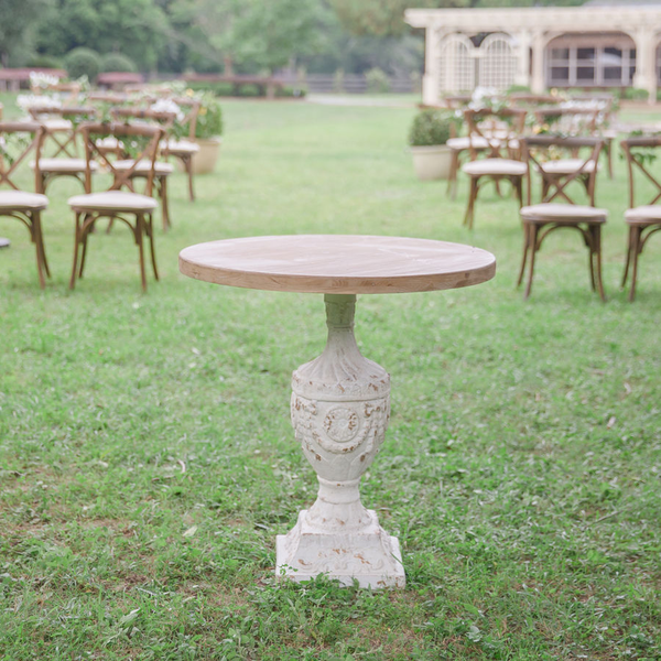 French plaster table with wood top at wedding ceremony with Sonoma chairs in background at The Space at Feather Oaks.