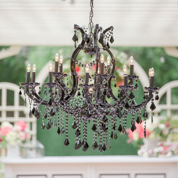 Black chandelier hanging in arbor at wedding reception at The Space at Feather Oaks.