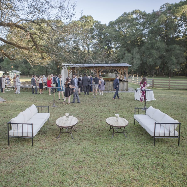 Iron seating and oval coffee tables for cocktail hour at wedding at The Space at Feather Oaks.