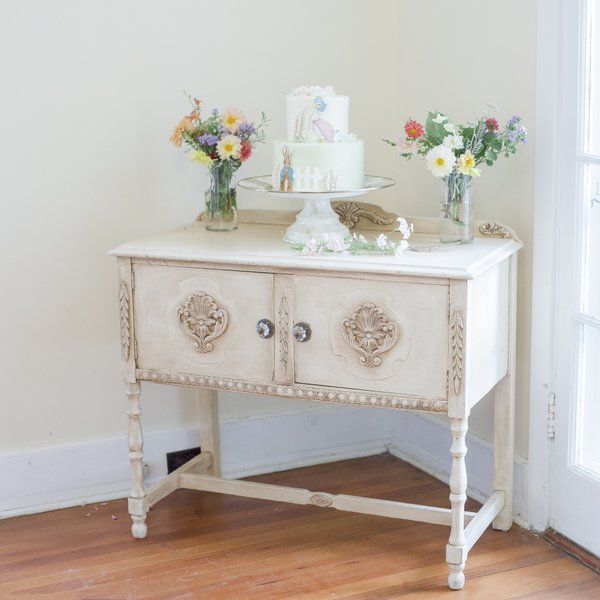 Peter Rabbit baby shower with wild flowers on top vintage table.
