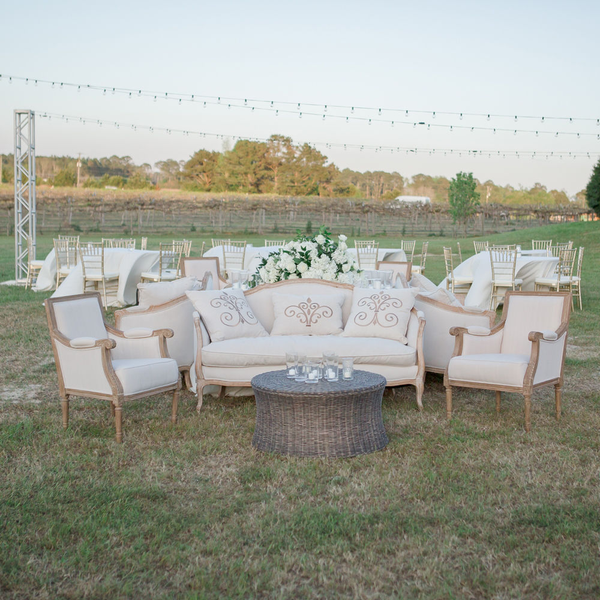 Wedding lounge area outside wedding with wicker coffee table at Gin Creek.