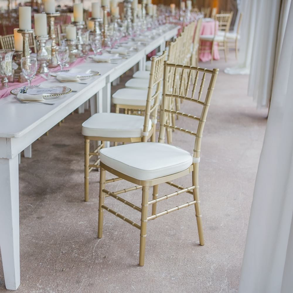 Gold Chiavari chairs inside barn wedding at Loblolly in Thomasville, GA.