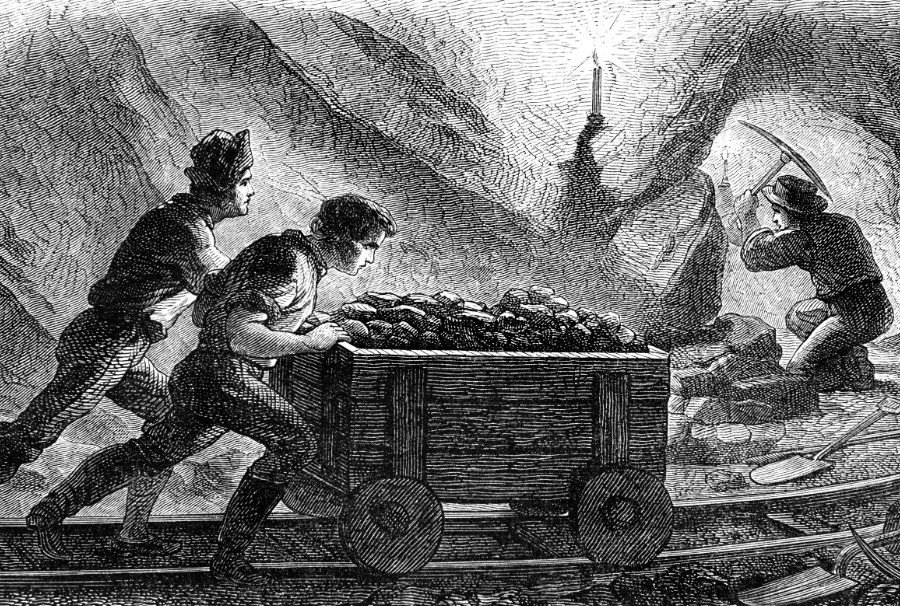 people pushing a trolley down a mine