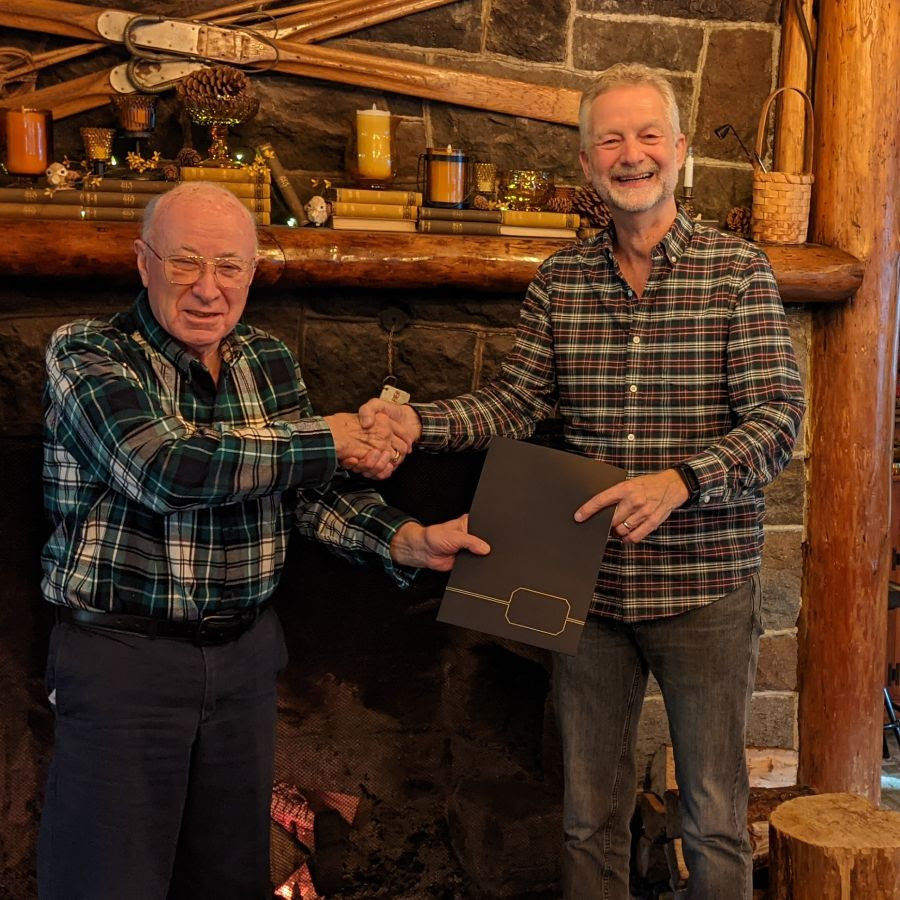 Tom Miller (YGA Board Chairman) and Calvin Tadema (Sanctuary Inn Board Chairman) exchange paperwork to celebrate the completion of our loan payment with the Youth Guidance Association, the previous owners of the Sanctuary Inn Property.