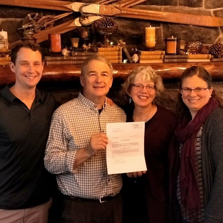 Dan Abbott, Steve Price, Joann Price, and Kara Githens (Sanctuary Inn Staff Team) celebrating this significant moment.