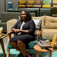Emily Wangui posing for a photo in the showroom of Furniture Zoo in Nairobi, Kenya