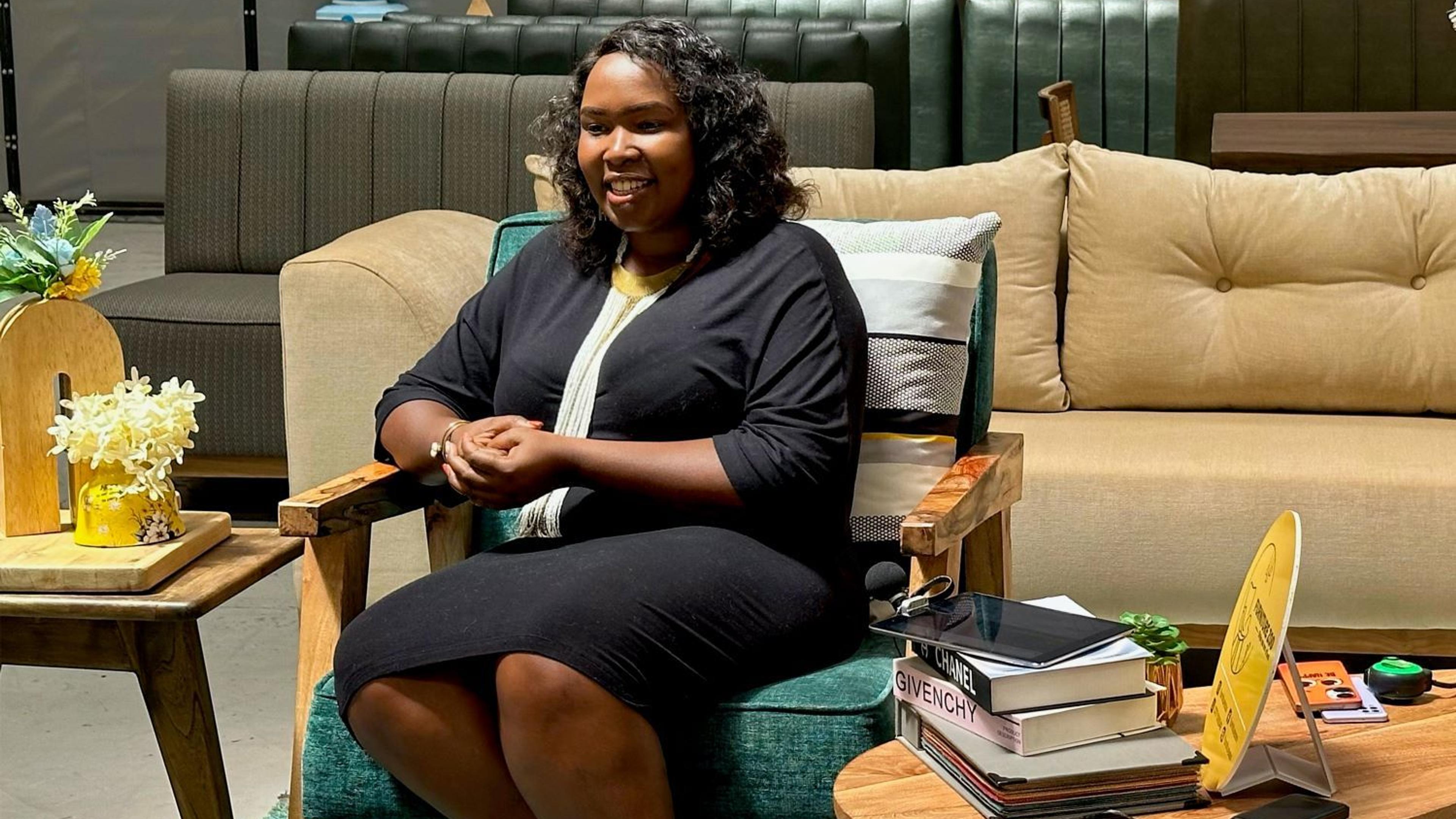 Emily Wangui posing for a photo in the showroom of Furniture Zoo in Nairobi, Kenya