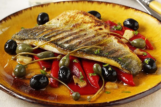 Lubina a la sarten con aceitunas Spanish Tapas Bars Restaurant, Pan-fried sea bass with Spanish olives, piquillo peppers, dry Sherry.