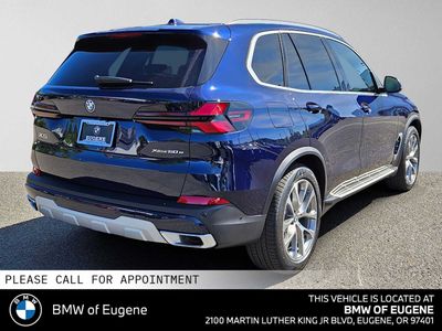 2026 BMW X5 xDrive50e — rear three-quarter view