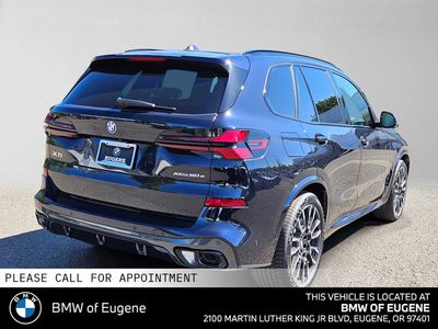 2026 BMW X5 xDrive50e — rear three-quarter view