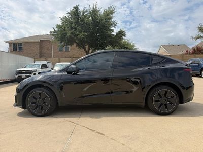 2024 Tesla Model Y — rear three-quarter view