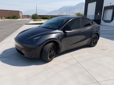 2024 Tesla Model Y — rear three-quarter view