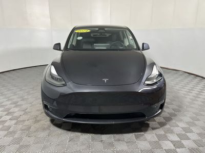 2024 Tesla Model Y — rear three-quarter view