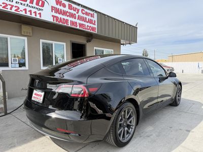 2021 Tesla Model 3 — rear three-quarter view