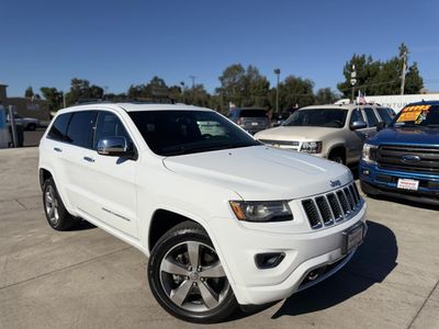 2014 Jeep Grand Cherokee in White — front three-quarter view