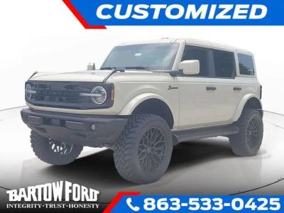 2026 Ford Bronco Outer Banks LIFTED / WHEELS & TIRES in Desert Sand — front three-quarter view