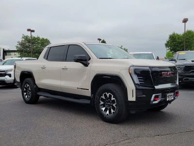 2026 GMC Sierra EV AT4 in Coastal Dune — front three-quarter view