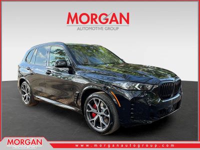2026 BMW X5 xDrive50e in Black Sapphire Metallic — front three-quarter view