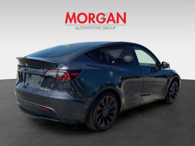 2025 Tesla Model Y — rear three-quarter view