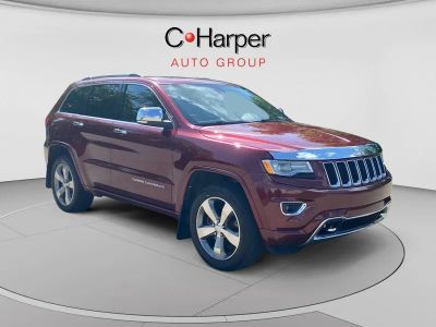 2016 Jeep Grand Cherokee Overland in Velvet Red Pearlcoat — front three-quarter view
