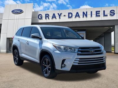 2019 Toyota Highlander LE Plus in Blizzard Pearl — front three-quarter view