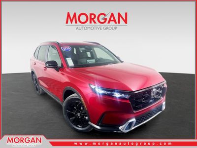 2026 Honda CR-V Hybrid Sport Touring in Red — front three-quarter view