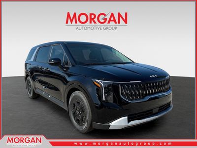 2026 Kia Carnival LXS in Aurora Black Pearl — front three-quarter view