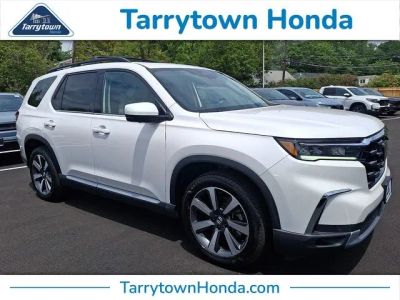 2023 Honda Pilot Elite in Platinum White Pearl — front three-quarter view