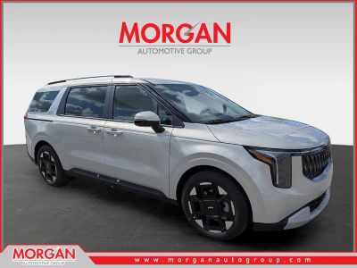 2026 Kia Carnival EX in Ivory Silver — front three-quarter view