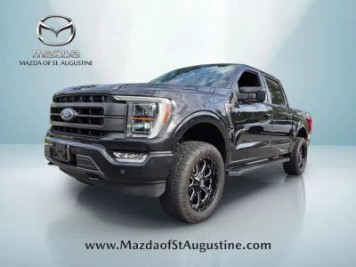 2023 Ford F-150 Lariat in Black — front three-quarter view