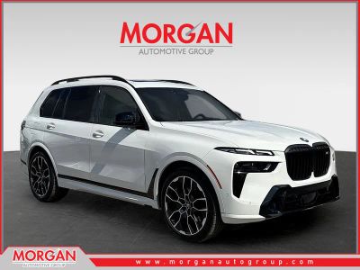 2025 BMW X7 M60i in Alpine White — front three-quarter view