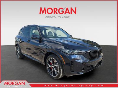 2026 BMW X5 xDrive50e in CARBON BLK MET — front three-quarter view