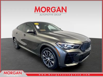 2022 BMW X6 xDrive40i in Green Metallic — front three-quarter view