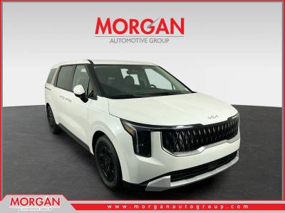 2026 Kia Carnival LXS in Snow White Pearl — front three-quarter view