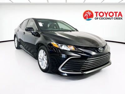 2024 Toyota Camry LE in Midnight Black Metallic — front three-quarter view