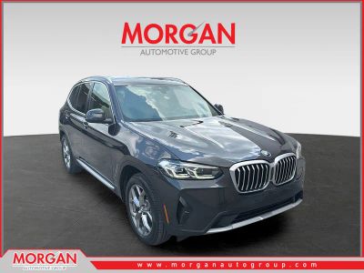 2023 BMW X3 xDrive30i in Dark Graphite Metallic — front three-quarter view