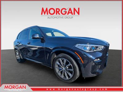 2021 BMW X5 M50i in Carbon Black Metallic — front three-quarter view
