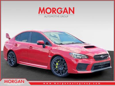 2019 Subaru WRX STI in Pure Red — front three-quarter view