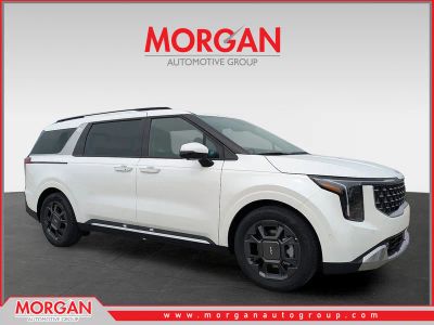 2026 Kia Carnival SX in Snow White Pearl — front three-quarter view