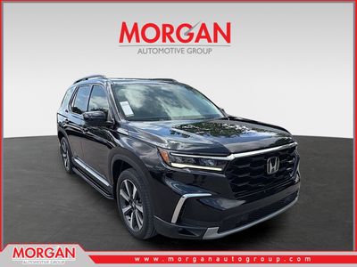 2023 Honda Pilot Touring in Crystal Black Pearl — front three-quarter view