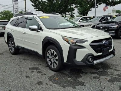 2025 Subaru Outback Touring AWD in Crystal White Pearl — front three-quarter view