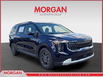 2026 Kia Carnival Hybrid EX in Deep Chroma Blue — front three-quarter view