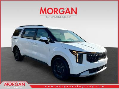 2026 Kia Carnival Hybrid EX in White — front three-quarter view
